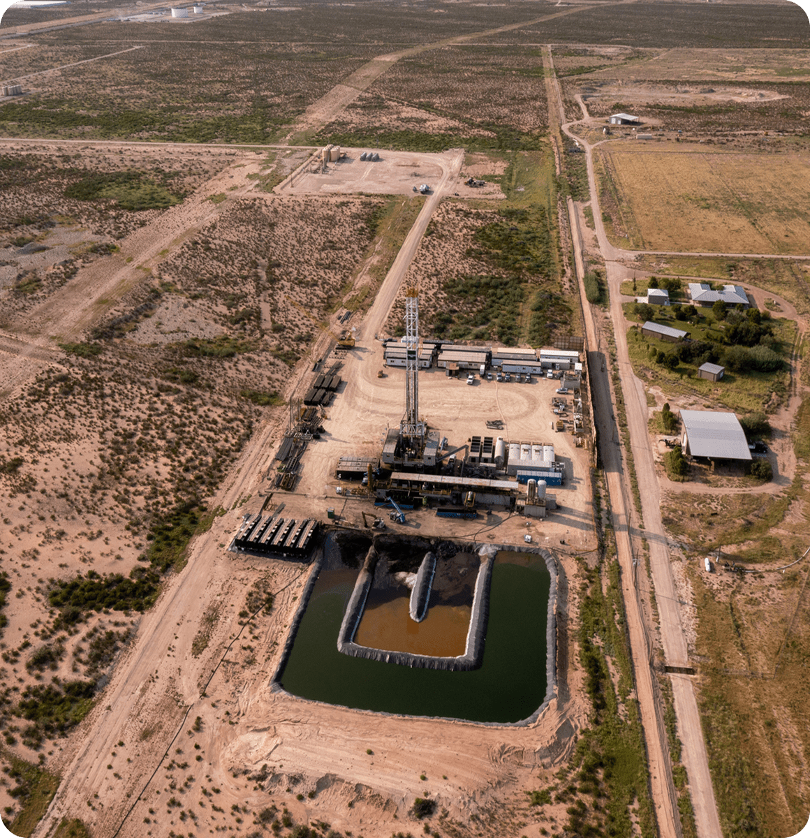 Oil drilling site with storage pond
