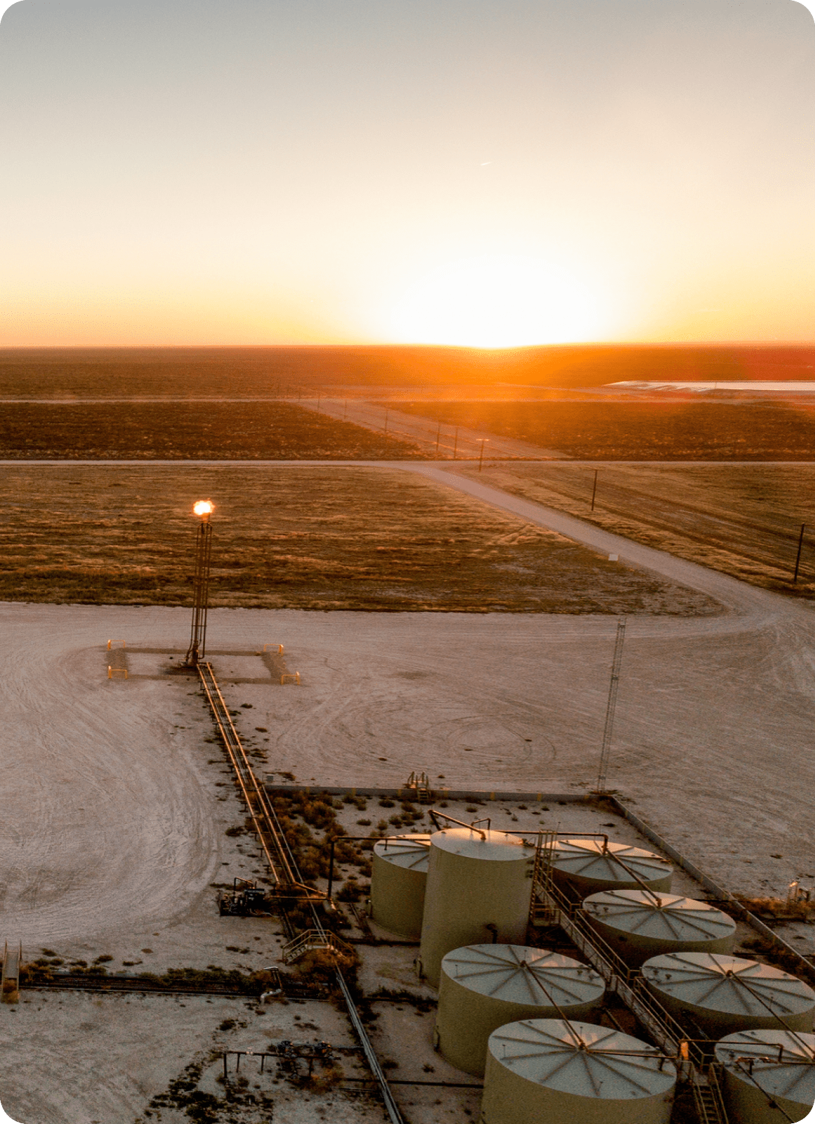 Rural oil facility during sunset.